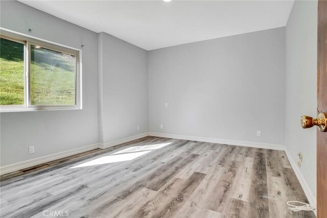 15470 Longbow, Sherman Oaks, CA 91403 - unfurnished room featuring baseboards, wood finished floors, and visible vents