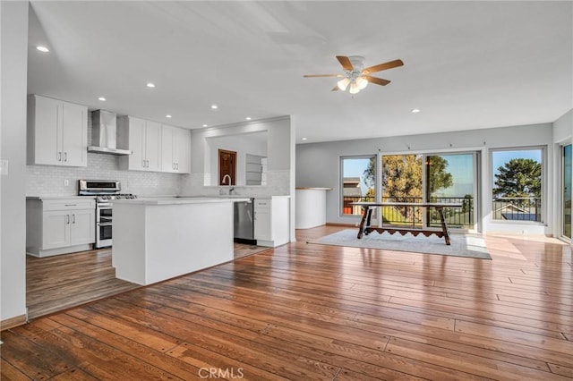 15470 Longbow, Sherman Oaks, CA 91403 - kitchen featuring light countertops, wood-type flooring, open floor plan, stainless steel appliances, and wall chimney exhaust hood