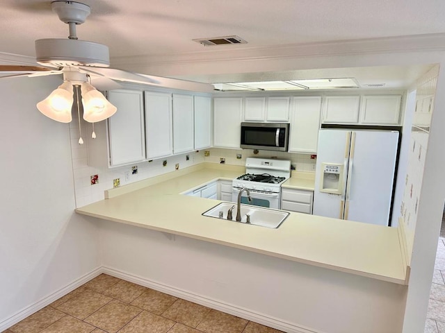 kitchen with white appliances, visible vents, a sink, and backsplash