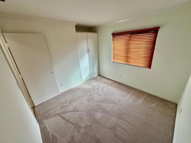 4741 Sequoia Pl, Oceanside, CA 92057 - unfurnished bedroom with light colored carpet, crown molding, a closet, and baseboards