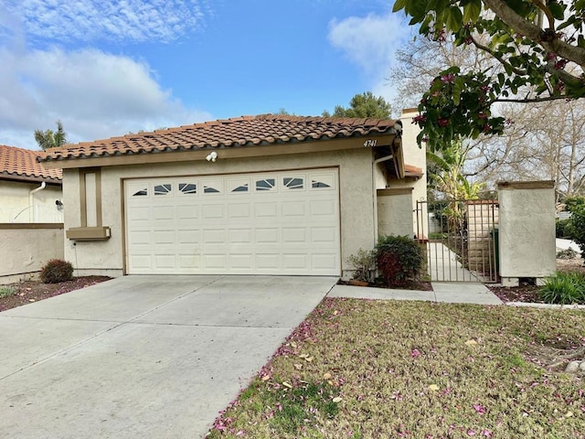 4741 Sequoia Pl, Oceanside, CA 92057 - mediterranean / spanish home with concrete driveway, stucco siding, a garage, a gate, and a tile roof
