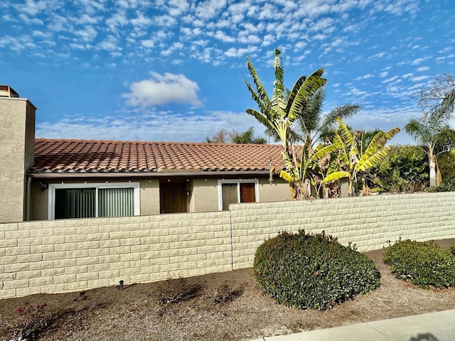 4741 Sequoia Pl, Oceanside, CA 92057 - view of front facade with fence, a tile roof, and stucco siding