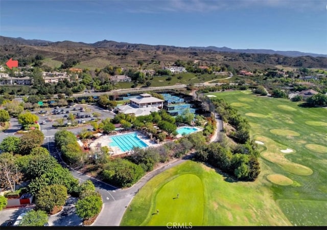 aerial view featuring view of golf course and a mountain view