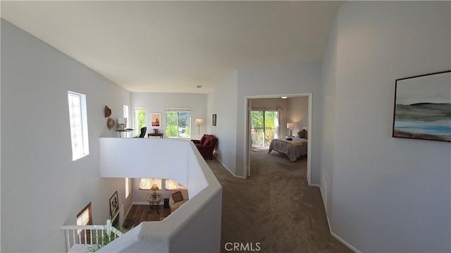 hallway with carpet flooring and baseboards