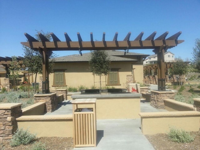 view of patio / terrace featuring outdoor dry bar and a pergola