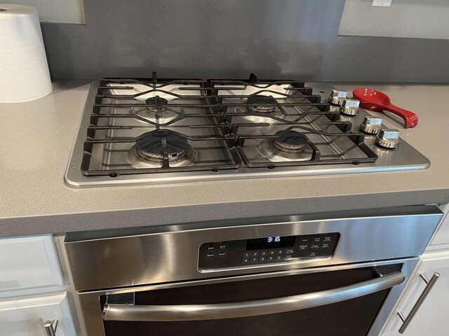 room details with white cabinetry and appliances with stainless steel finishes