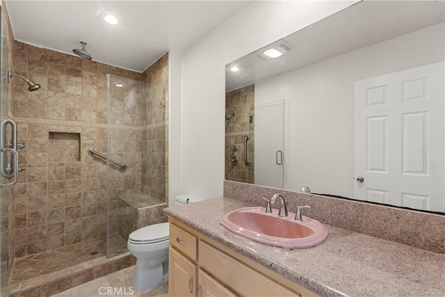 full bath featuring toilet, recessed lighting, vanity, tile patterned floors, and a stall shower