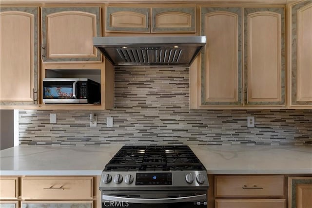 kitchen featuring premium range hood, appliances with stainless steel finishes, backsplash, and light brown cabinetry