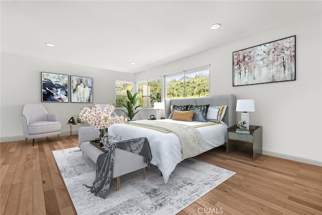 bedroom with recessed lighting, light wood-type flooring, and baseboards