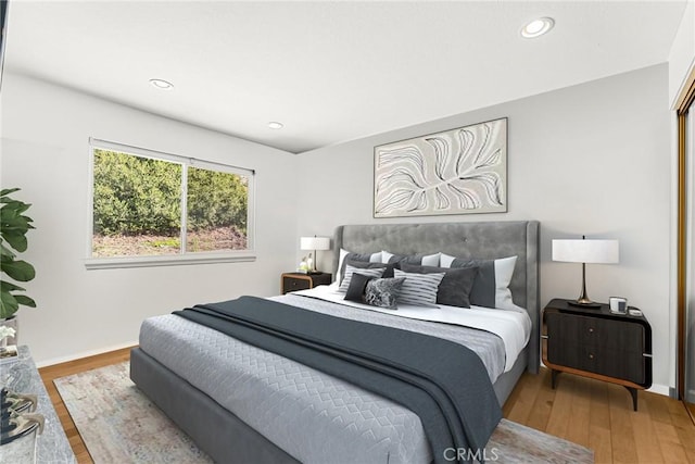 bedroom featuring recessed lighting, baseboards, and wood finished floors