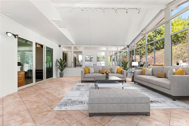 sunroom featuring lofted ceiling and french doors