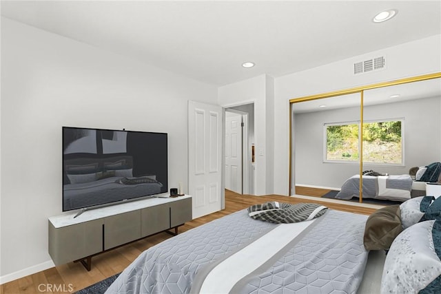 bedroom featuring recessed lighting, visible vents, baseboards, and wood finished floors