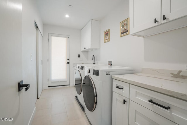 laundry area with cabinet space, light tile patterned floors, baseboards, washing machine and clothes dryer, and recessed lighting