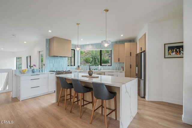 kitchen featuring tasteful backsplash, stainless steel fridge, and modern cabinets