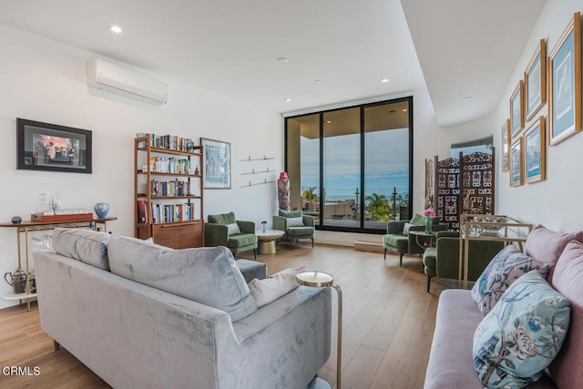 living area with recessed lighting, floor to ceiling windows, wood finished floors, and a wall mounted air conditioner