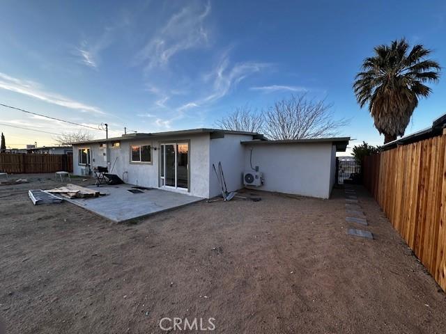 back of property featuring a fenced backyard, a patio, and stucco siding