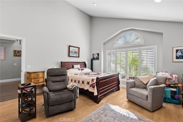 bedroom featuring baseboards, high vaulted ceiling, wood finished floors, and recessed lighting