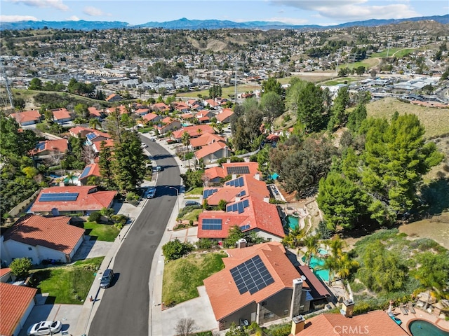 drone / aerial view featuring a residential view and a mountain view