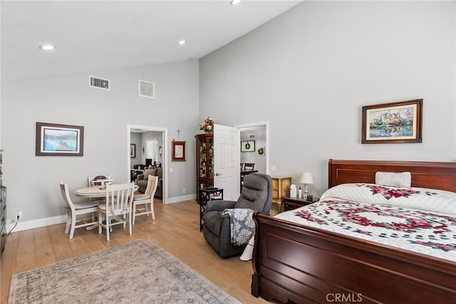 bedroom featuring baseboards, visible vents, and light wood-style floors