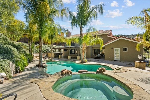 view of pool with a pool with connected hot tub and a patio