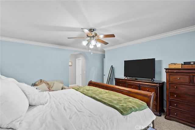 bedroom with arched walkways, ceiling fan, crown molding, and light colored carpet