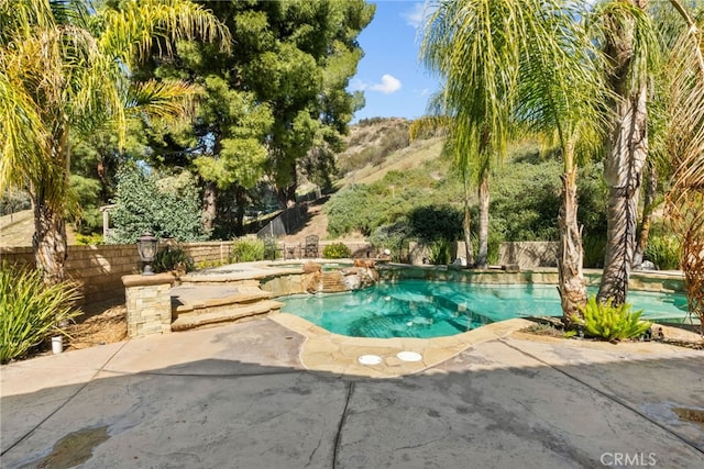 view of swimming pool featuring a fenced in pool, a patio area, a fenced backyard, and an in ground hot tub