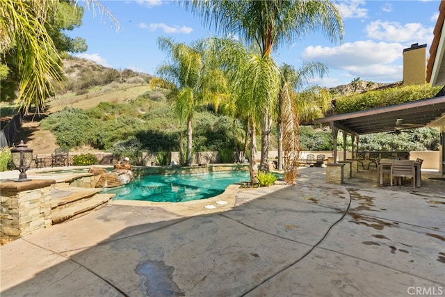 outdoor pool with a patio area