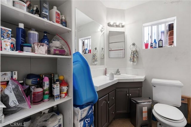 bathroom with tile patterned flooring, vanity, and toilet