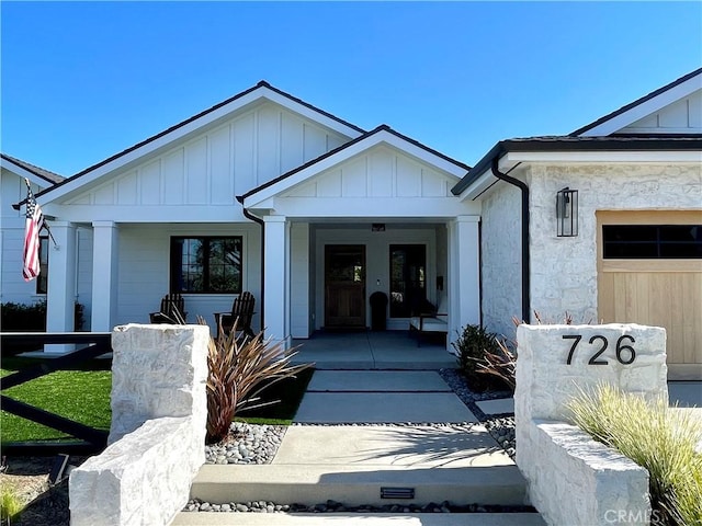 property entrance featuring a porch and board and batten siding