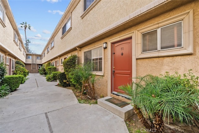 doorway to property with a patio area and stucco siding