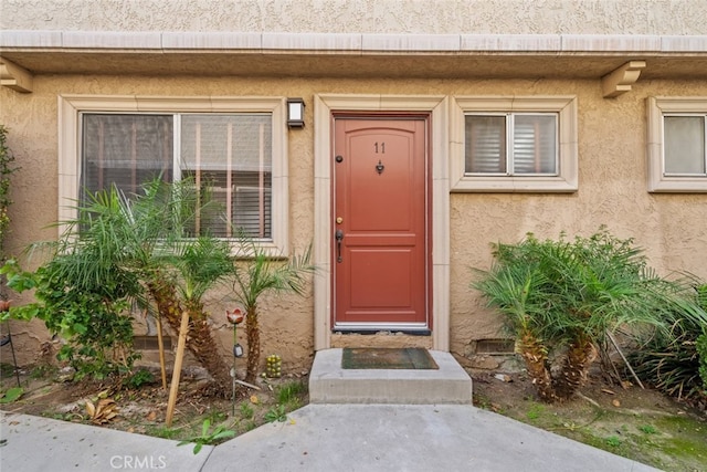 entrance to property with stucco siding