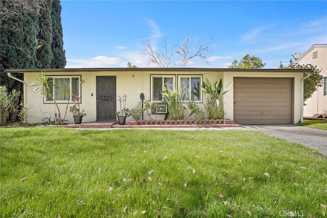 ranch-style house featuring a garage, driveway, a front lawn, and stucco siding