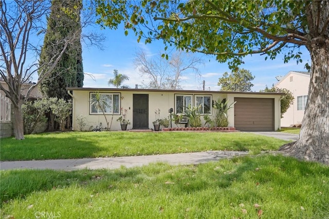 single story home with an attached garage, driveway, a front lawn, and stucco siding