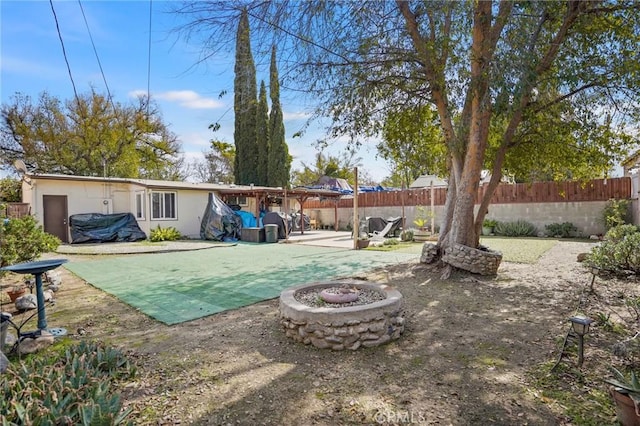 view of pool featuring a patio area, a fenced backyard, and a fire pit