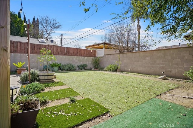 view of yard with a fenced backyard