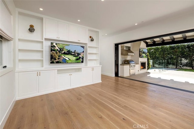 unfurnished living room featuring light wood-style flooring, baseboards, and recessed lighting