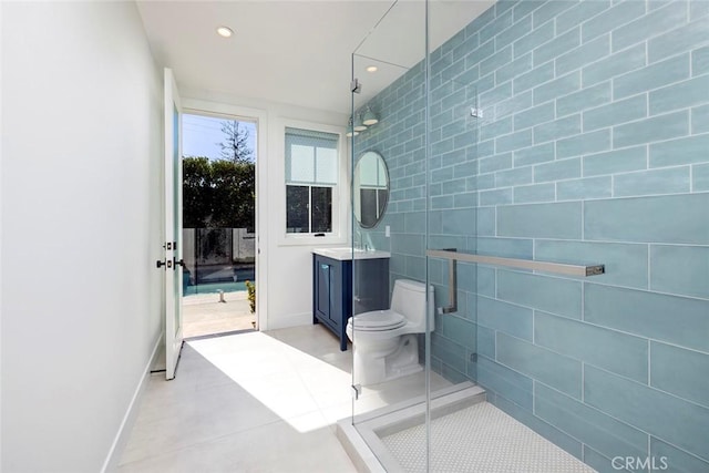 bathroom featuring tile patterned flooring, vanity, a shower stall, tile walls, and recessed lighting