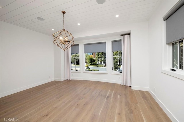 empty room featuring recessed lighting, an inviting chandelier, wood ceiling, light wood-type flooring, and baseboards