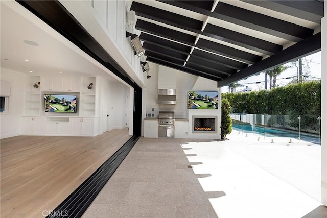 view of patio featuring a fenced in pool, fence, grilling area, and an outdoor kitchen