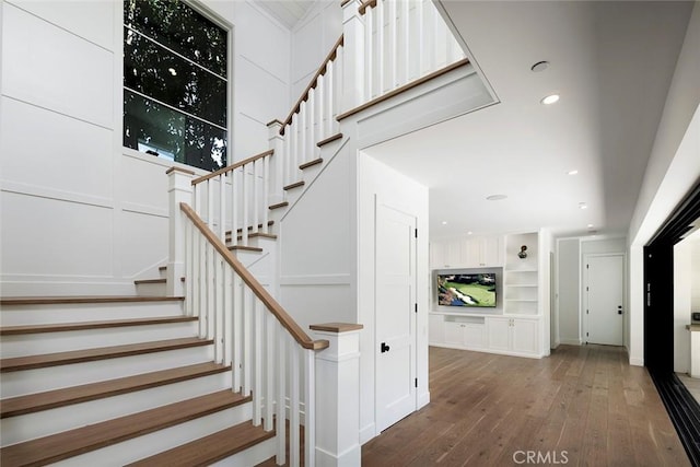 staircase featuring hardwood / wood-style floors and recessed lighting