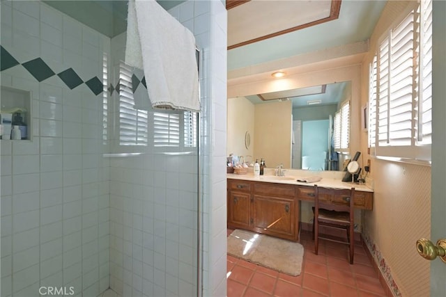 full bathroom featuring a stall shower, tile patterned flooring, vanity, and baseboards