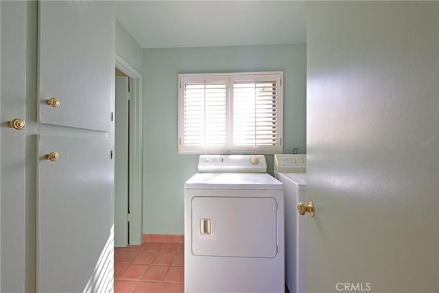 washroom with laundry area, light tile patterned floors, and independent washer and dryer