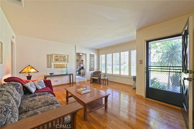 living room with visible vents and wood finished floors