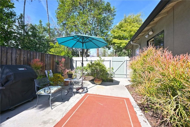 view of patio with fence and grilling area