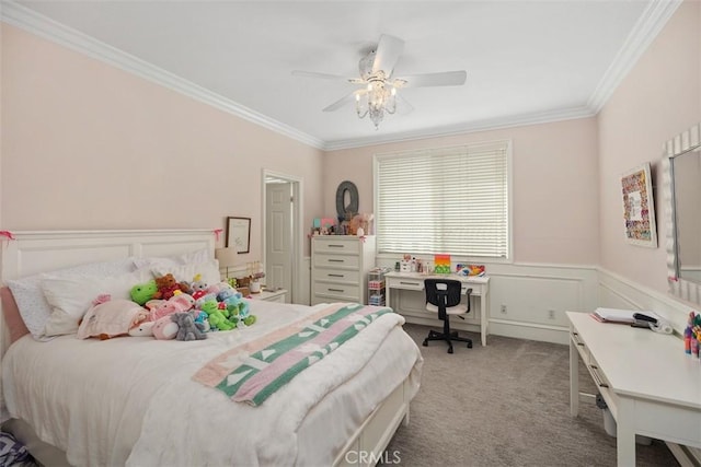 bedroom featuring ornamental molding, carpet, wainscoting, and a ceiling fan