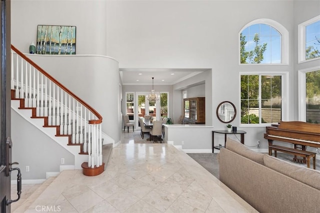 entryway featuring stairs, a high ceiling, and a healthy amount of sunlight