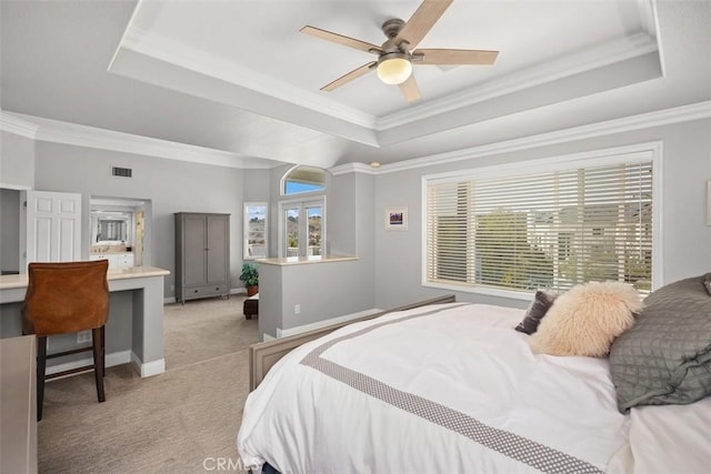 bedroom featuring light carpet, visible vents, baseboards, a raised ceiling, and crown molding