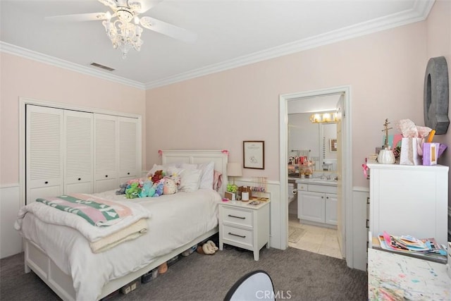 bedroom featuring light colored carpet, a closet, visible vents, and crown molding