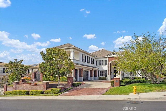 view of front of house with decorative driveway and an attached garage