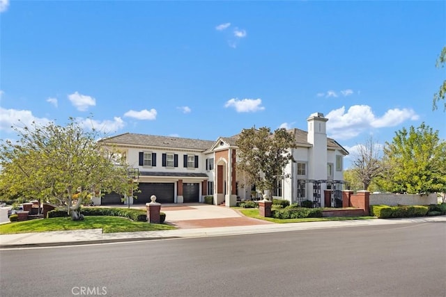 view of front of home featuring an attached garage, driveway, and stucco siding